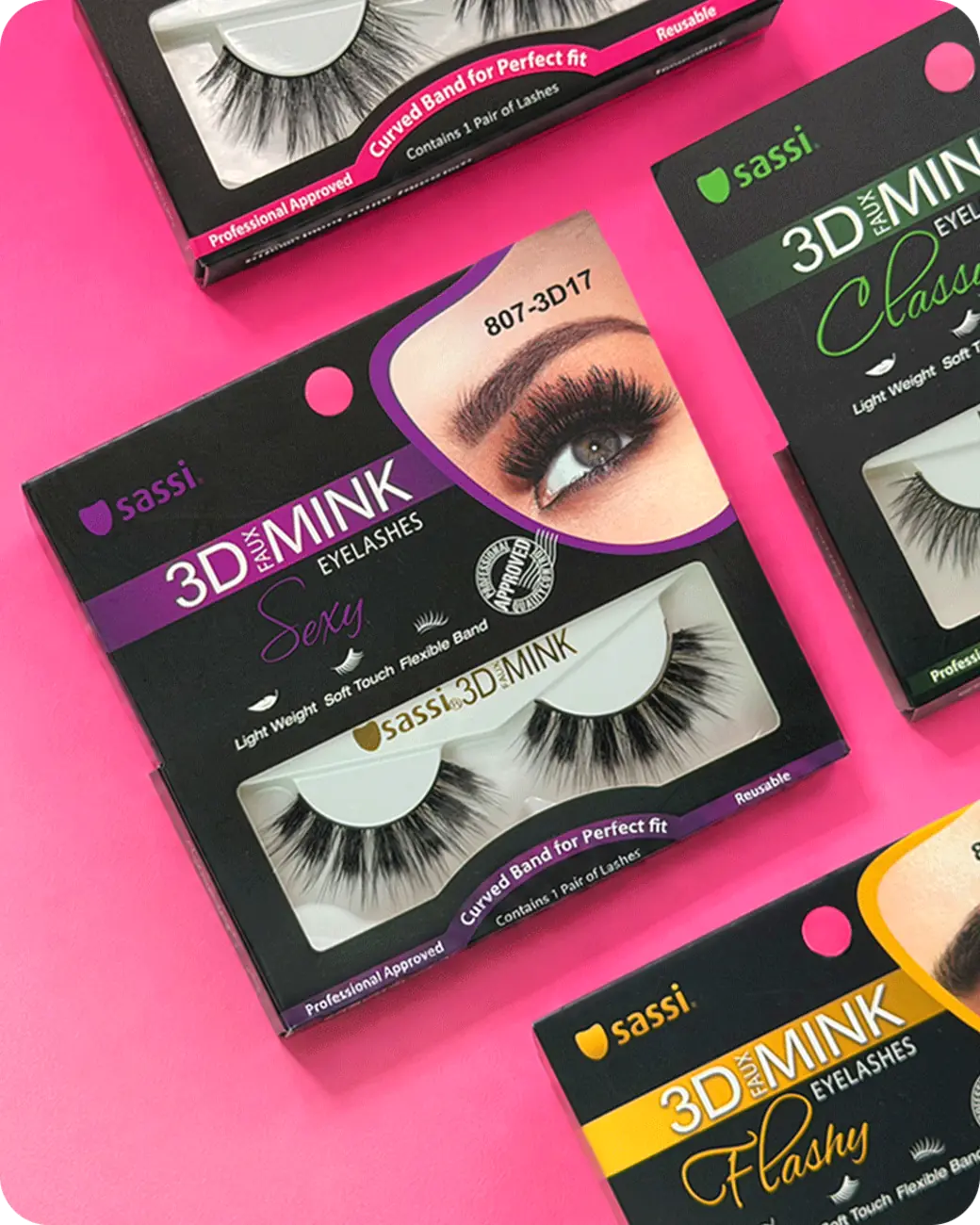 Sassi false eyelash packages arranged on a vivid pink background